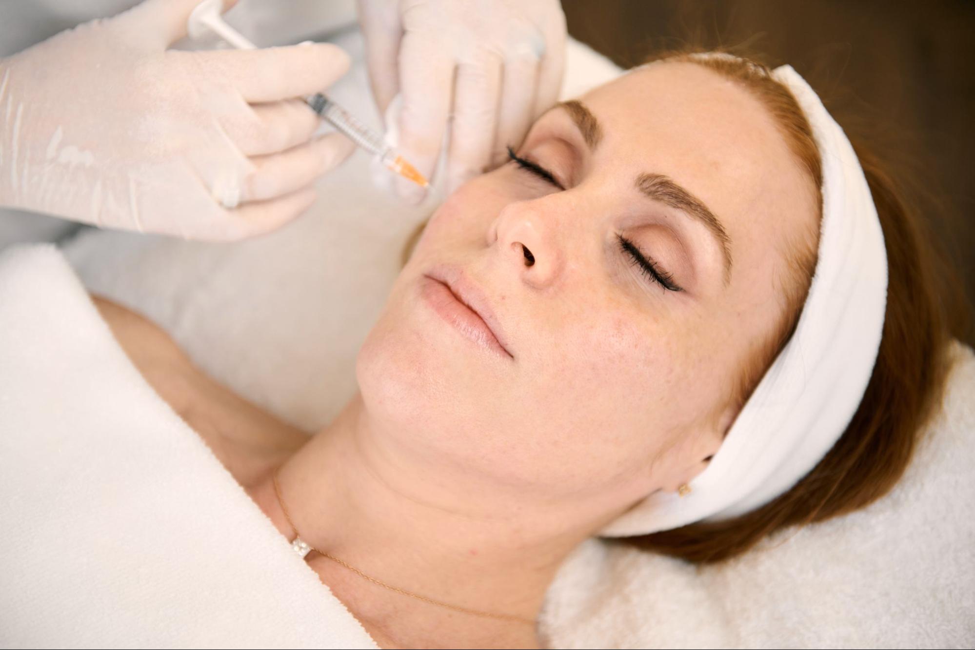 A practitioner administering an injectable facial treatment